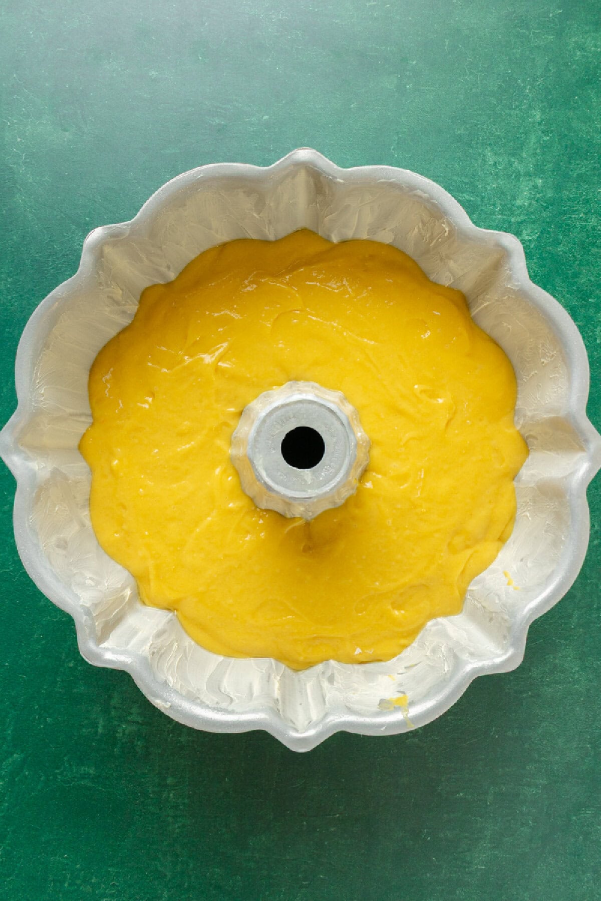cake batter spread evenly into a prepared bundt pan.