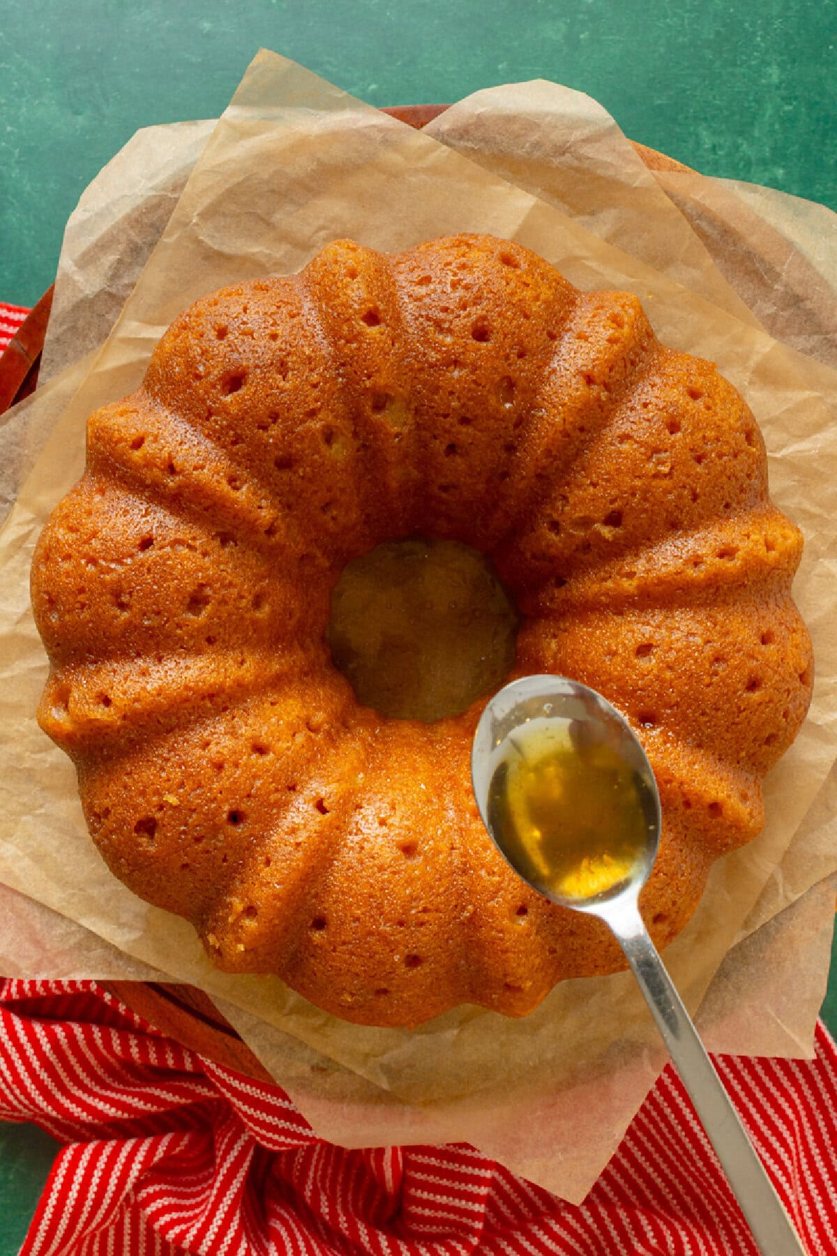 Glazing the cake with buttery rum syrup for ultimate moisture.