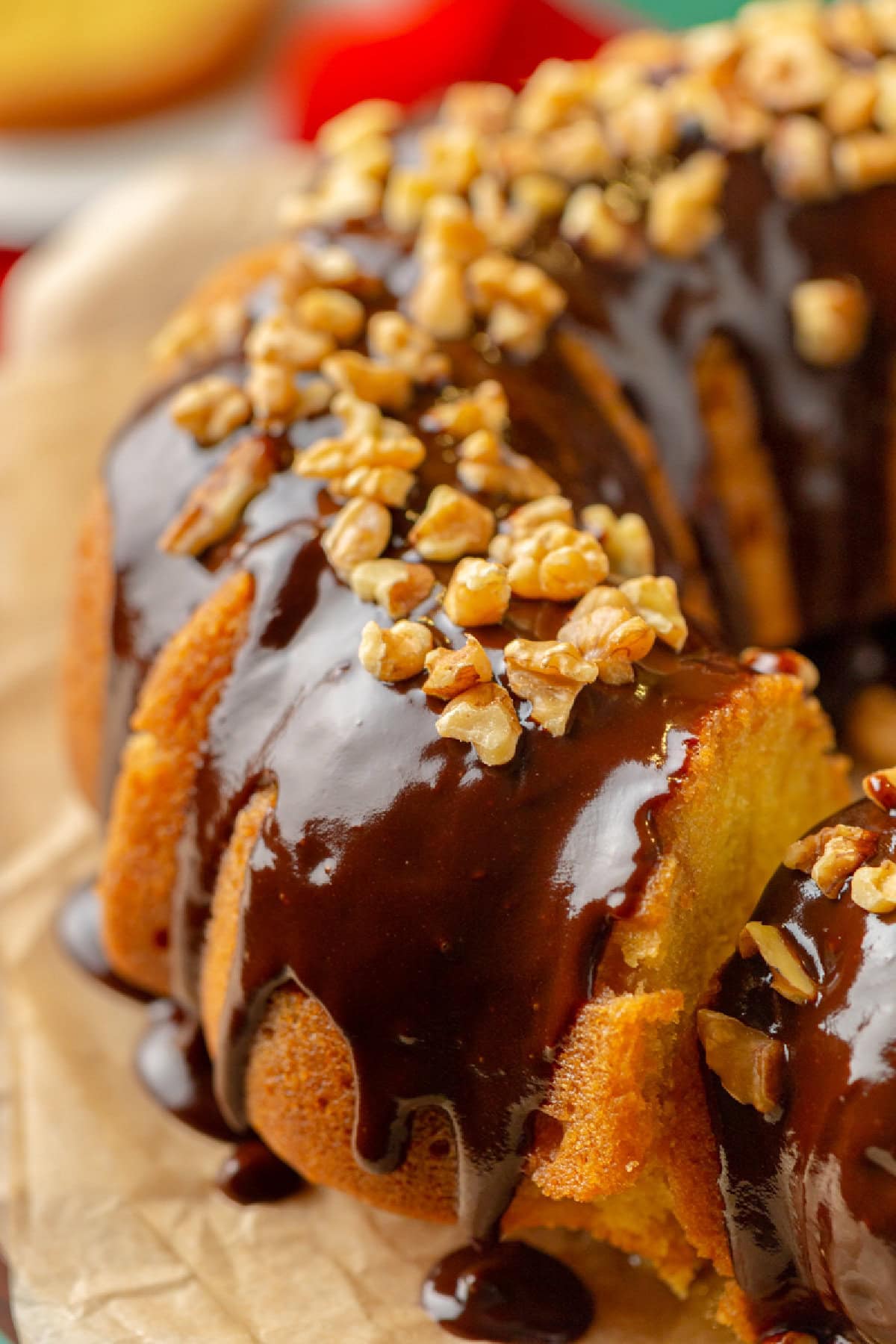 chocolate glaze drizzled on top of a rum cake with walnuts.