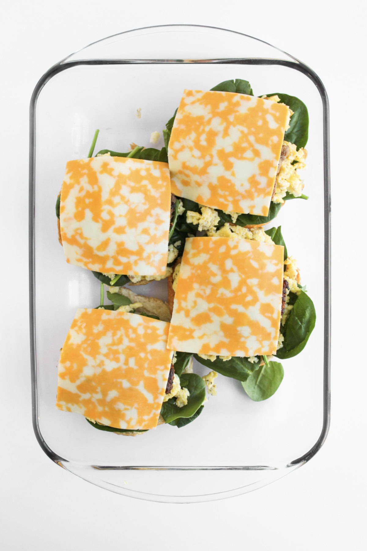 Colby Jack cheese on top of scrambled eggs, spinach, and croissants.