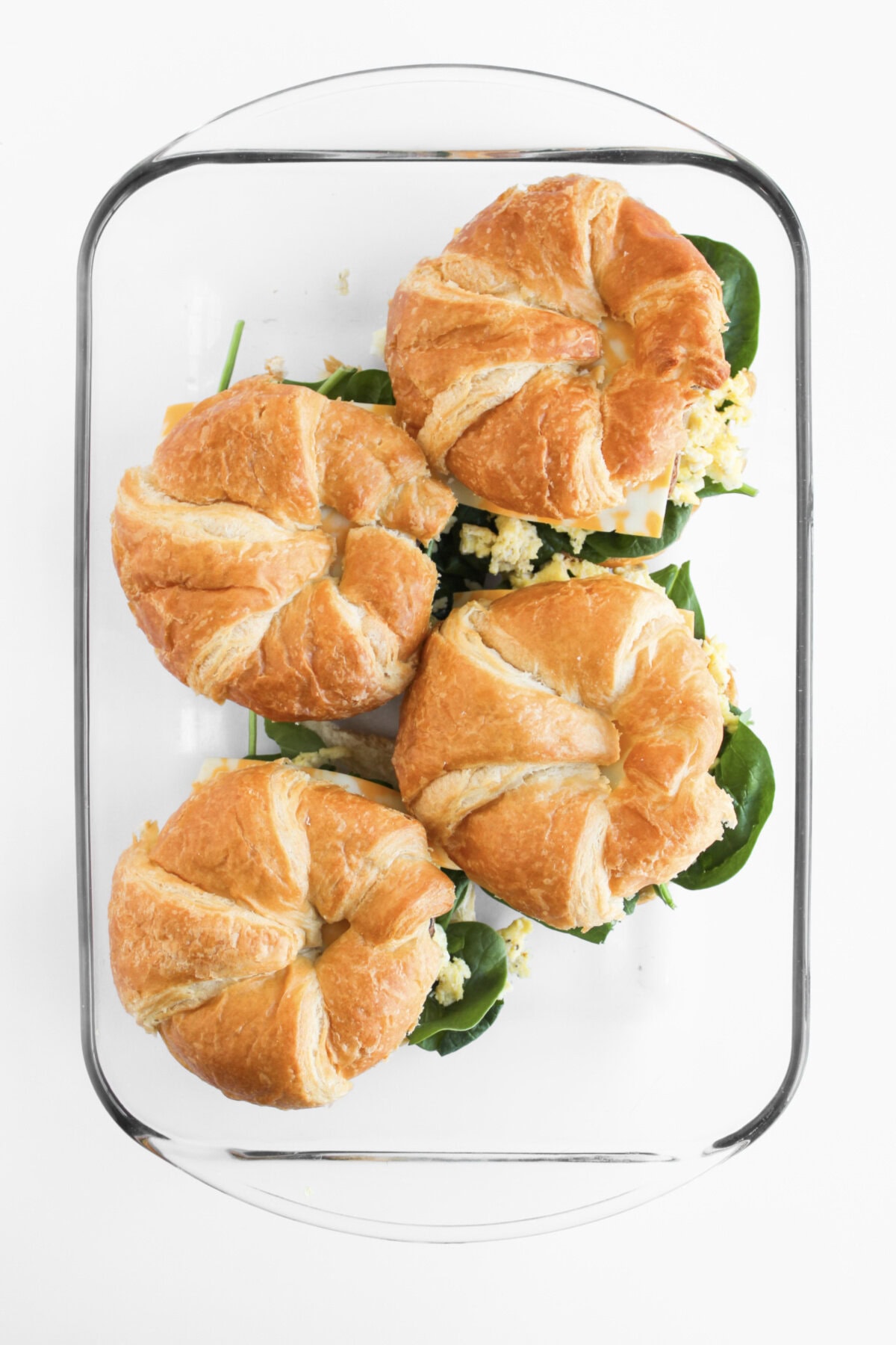 assembled breakfast sandwiches ready to brush with butter and place in oven.