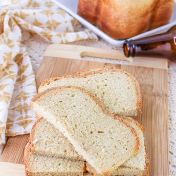 sliced bread machine beer bread on a wood cutting board.