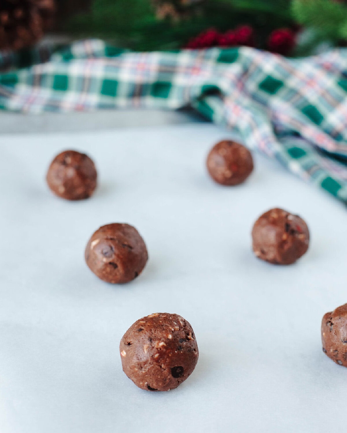 chocolate peppermint pudding cookie dough balls on a baking sheet.