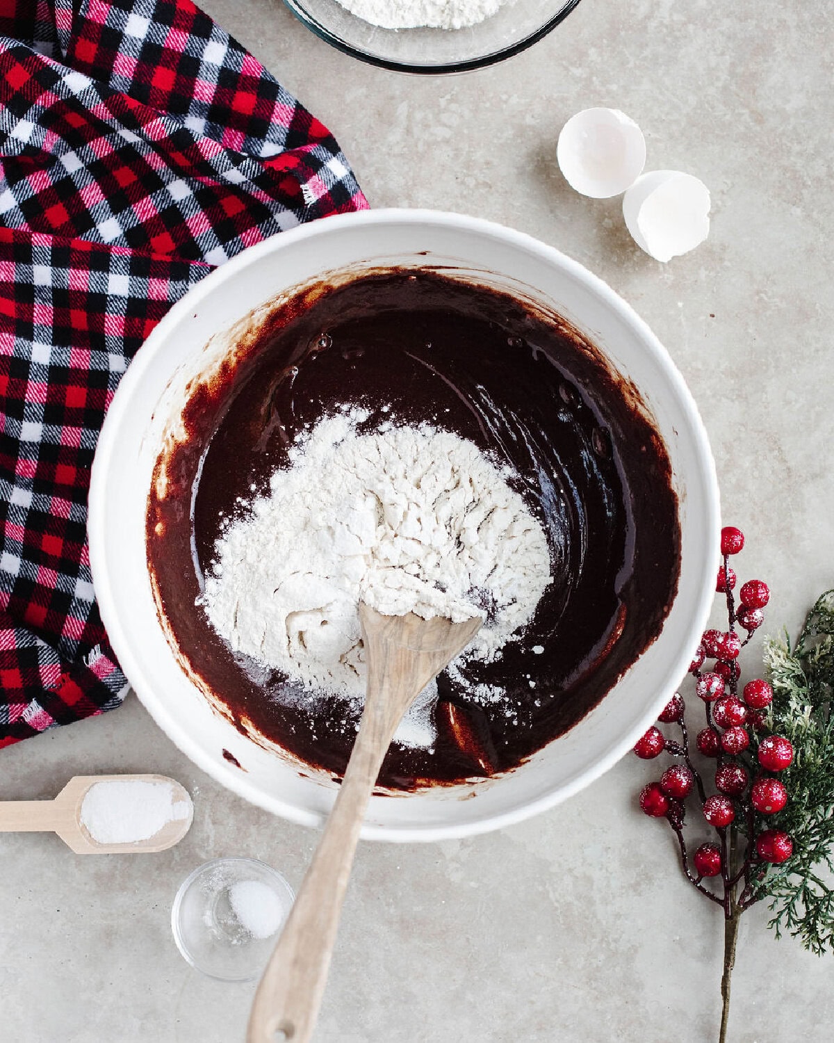dry ingredients being mixed into a wet ingredient cookie dough mixture.