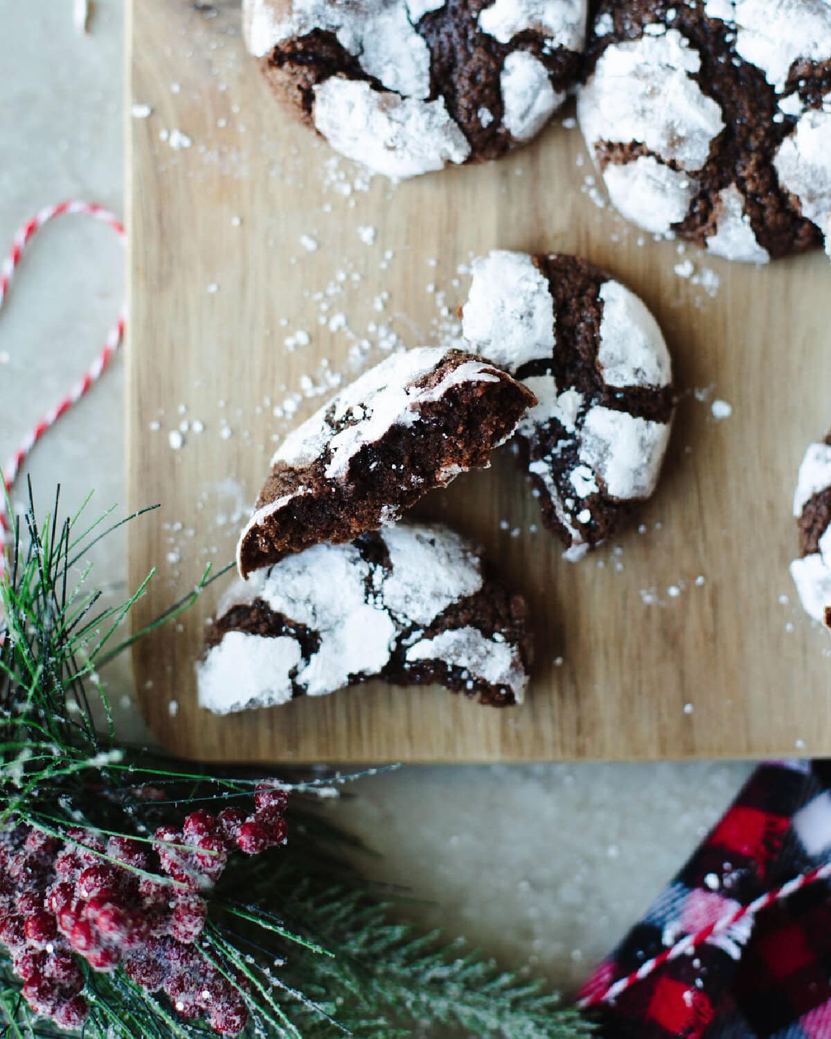 Betty Crocker Chocolate Crinkles baked and broken in half to show center on a wood cutting board.