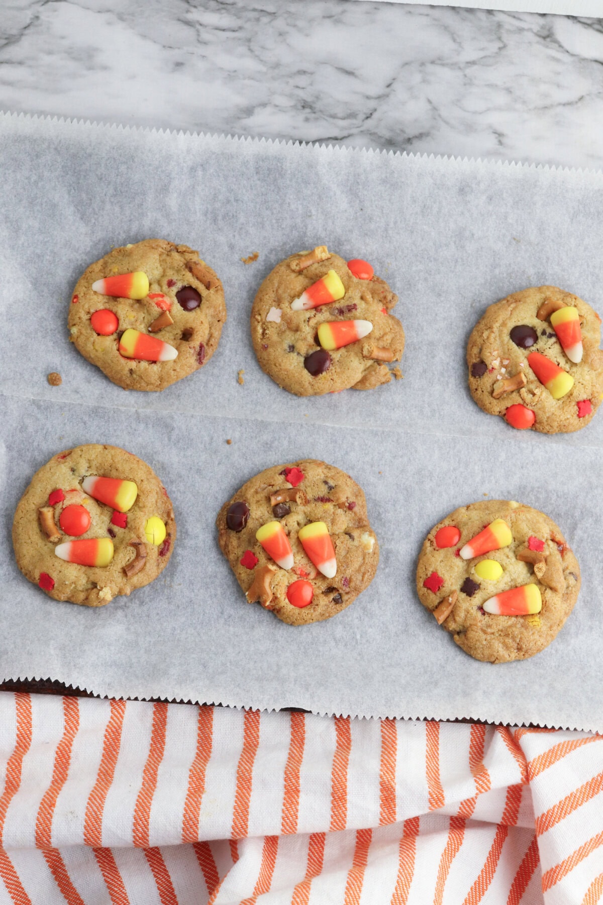 baked Fall kitchen sink cookies on a parchment paper lined cookie sheet.
