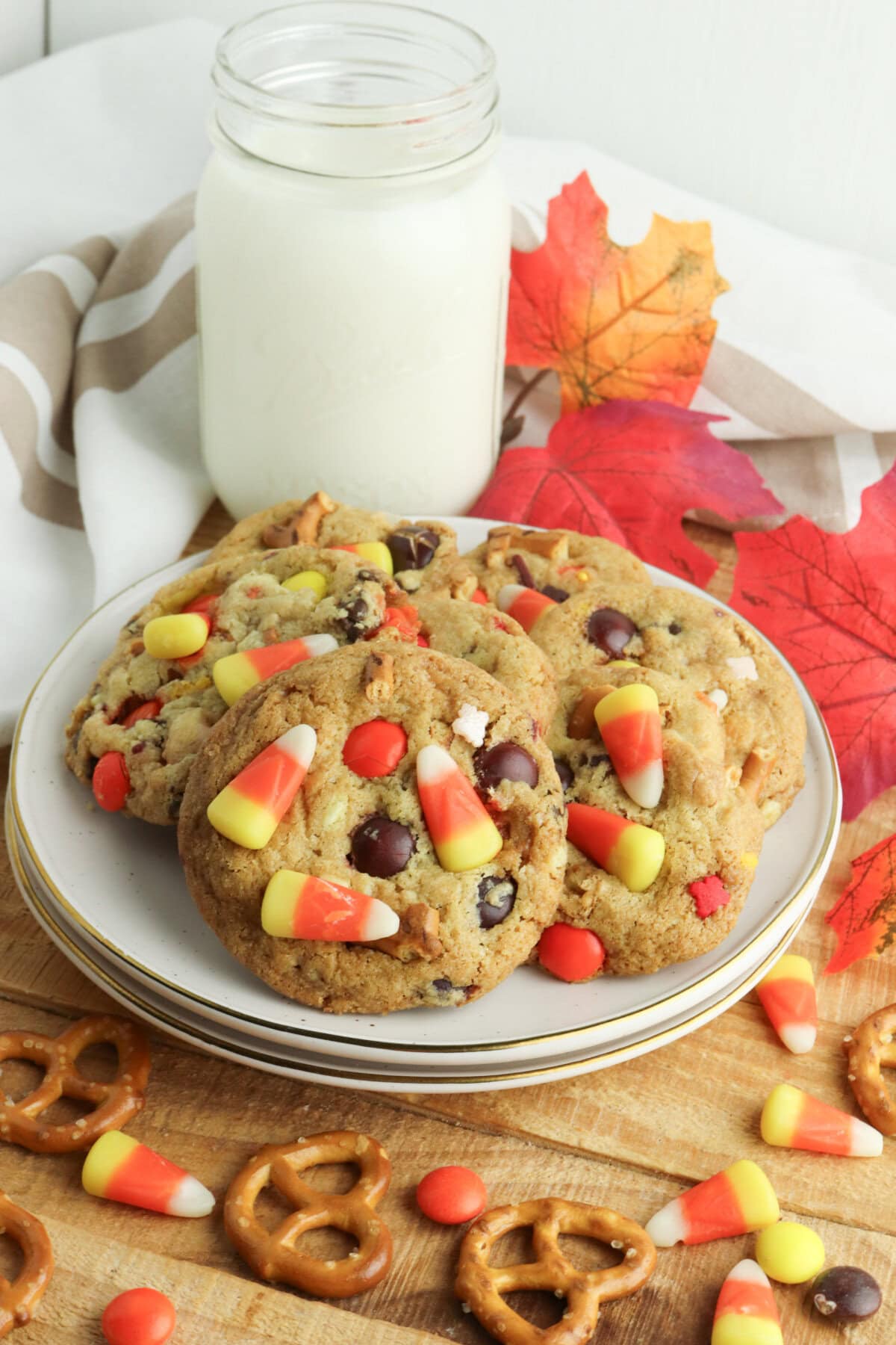 Kitchen Sink Cookies served on a plate with a glass of milk.