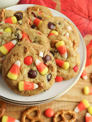 baked and ready to enjoy Fall Harvest Cookies on a stack of white plates.