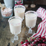 a creamy RumChata Christmas drink with a candy cane rim.