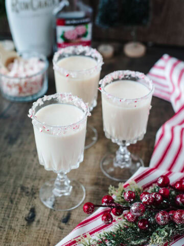 a creamy RumChata Chrsitmas drink with a candy cane rim.