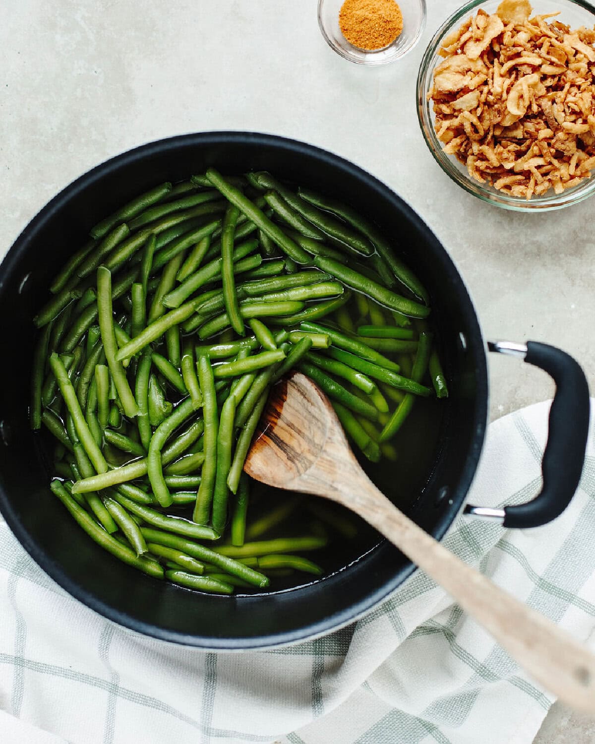green beans boiled in chicken broth to soften up in a pot.