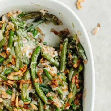 baked green bean casserole in a white baking dish.