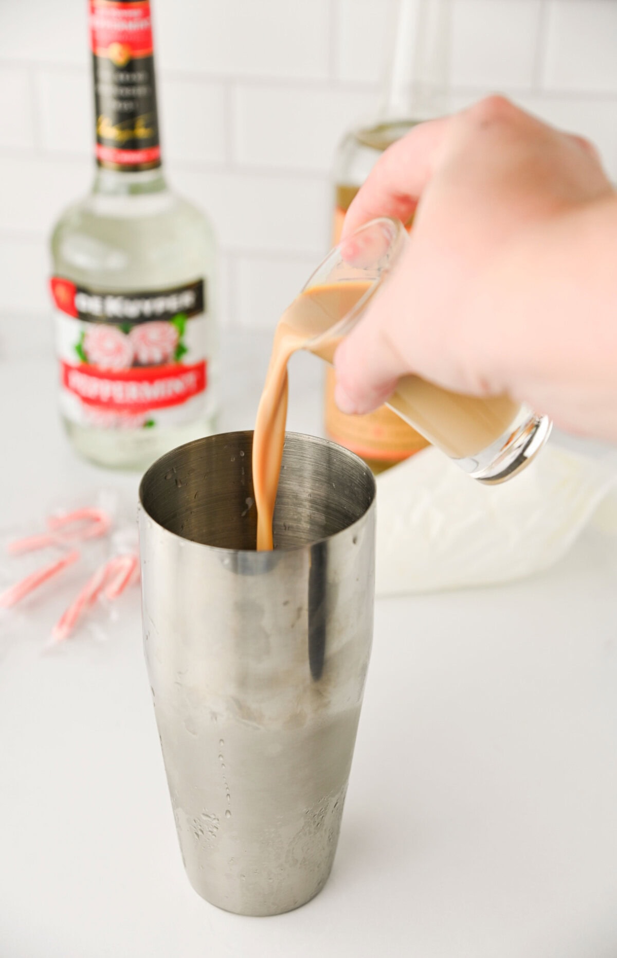 Bailey's Irish Cream poured into a cocktail shaker.