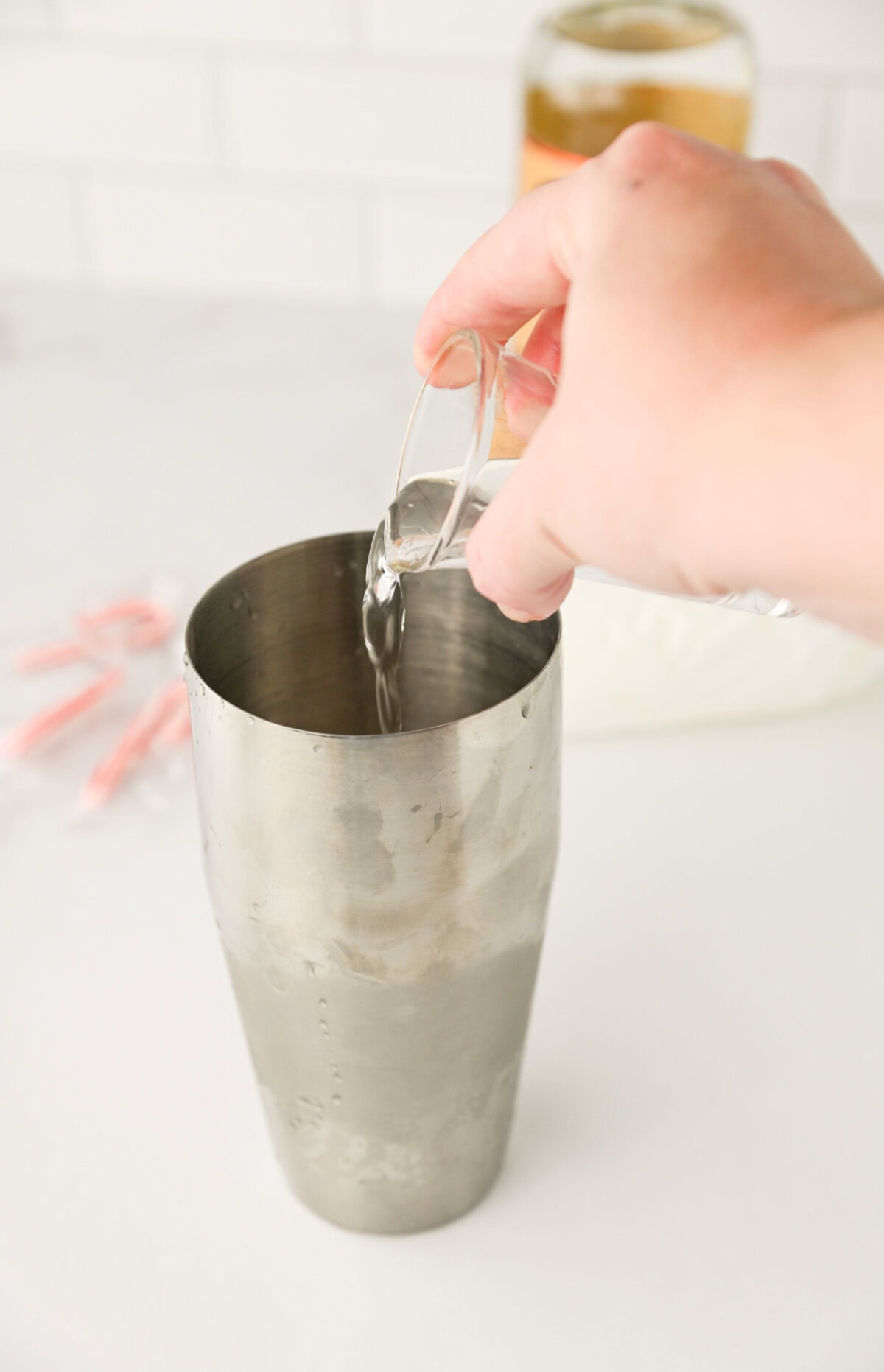 peppermint schnapps added to a cocktail shaker.