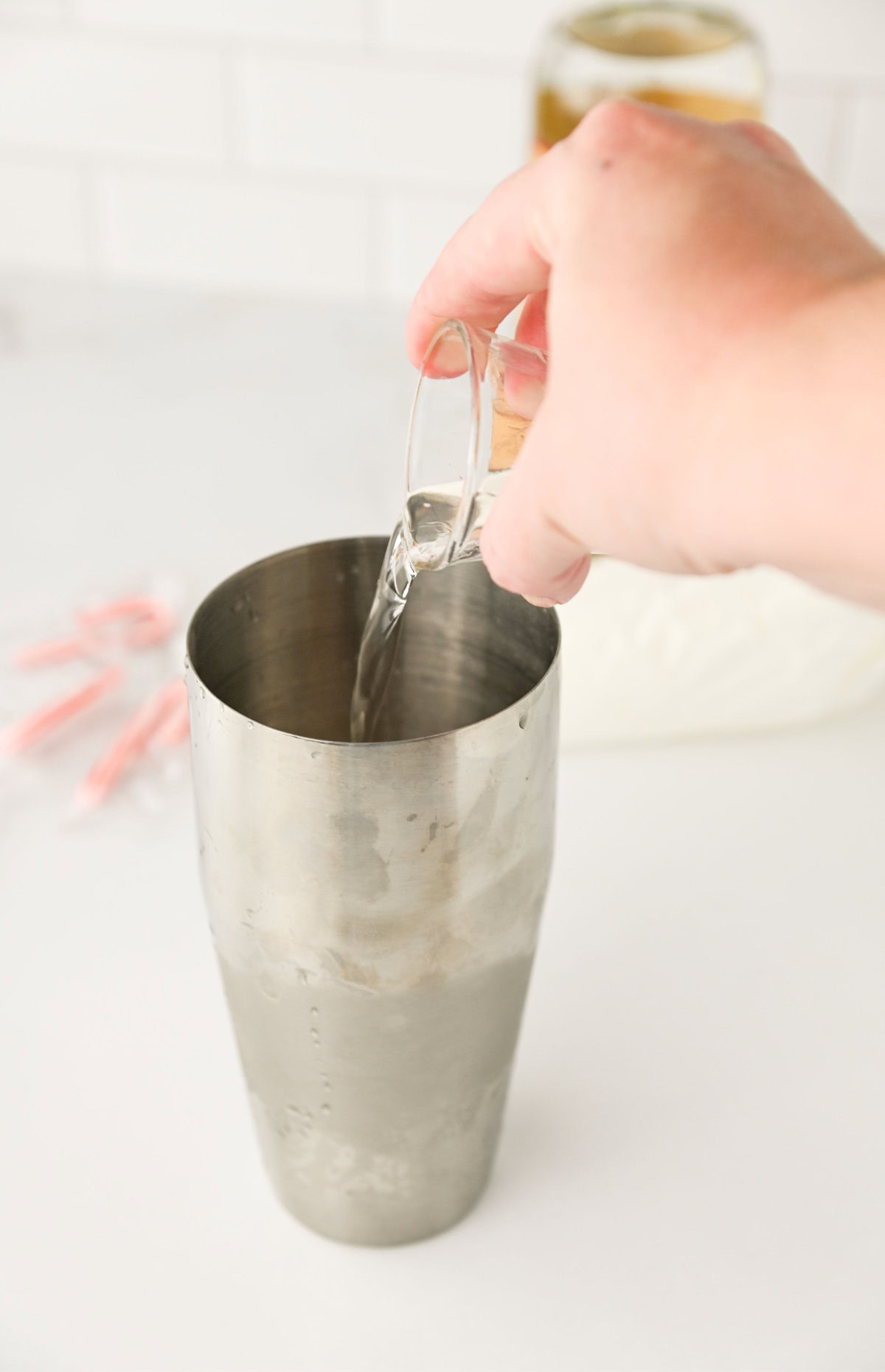 vodka added to a cocktail shaker.