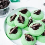 melted dark chocolate and an andes mint in the center of a mint thumbprint cookie.