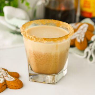 a Gingerbread White Russian Cocktail ready to serve with a gingerbread man cookie.