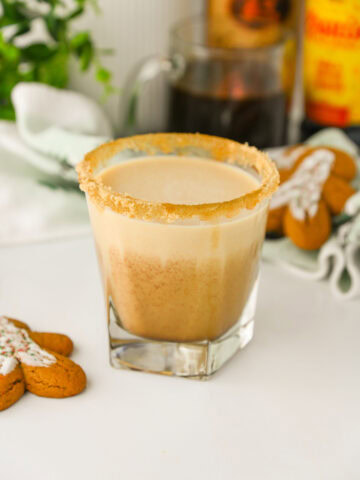 a Gingerbread White Russian Cocktail ready to serve with a gingerbread man cookie.