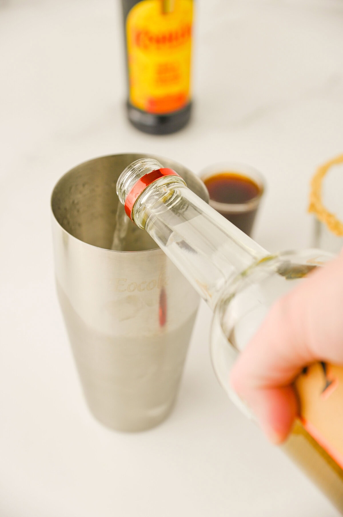 vodka added to a cocktail shaker.