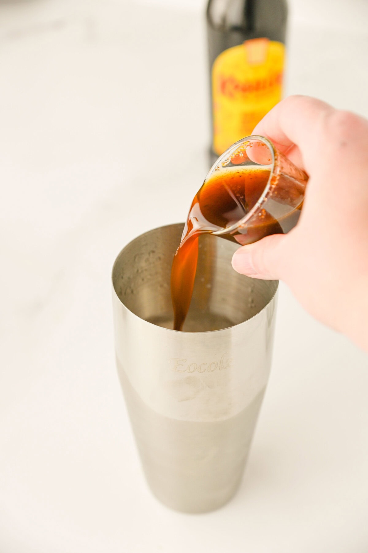 Kahlua poured into a cocktail shaker.