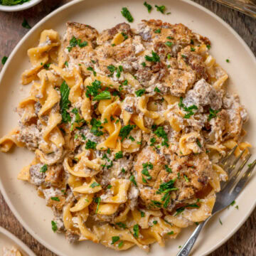 Beef stroganoff casserole served on a plate with a fork.
