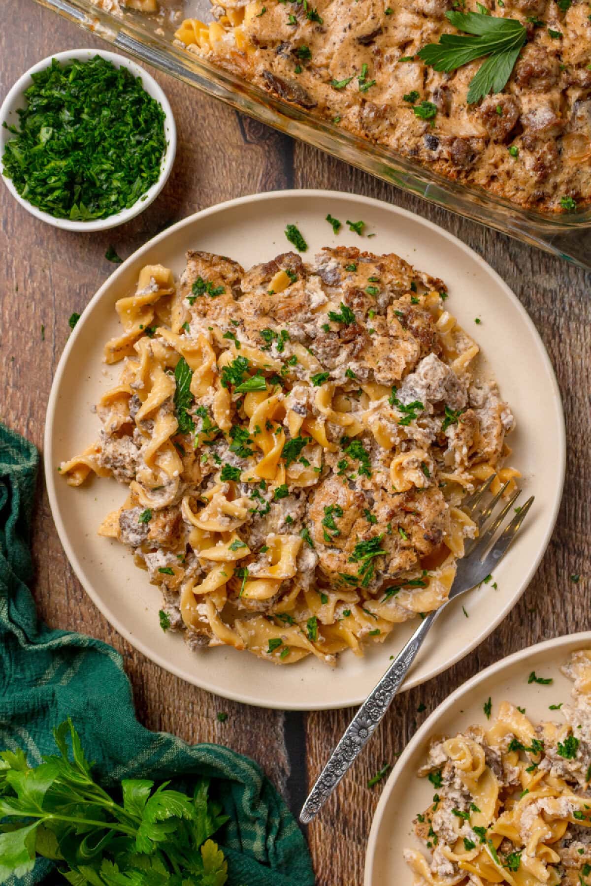 A serving of creamy stroganoff casserole on a plate with a fork.