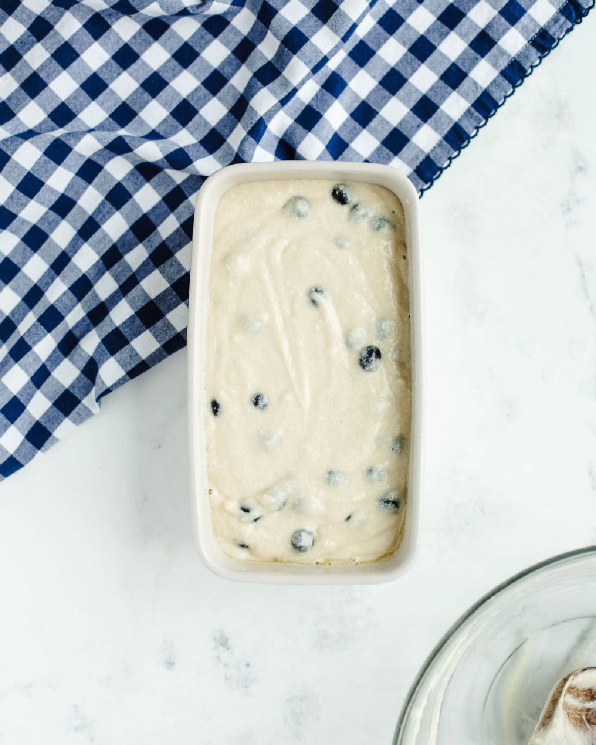 blueberry quick bread batter spread evenly into a prepared loaf pan.