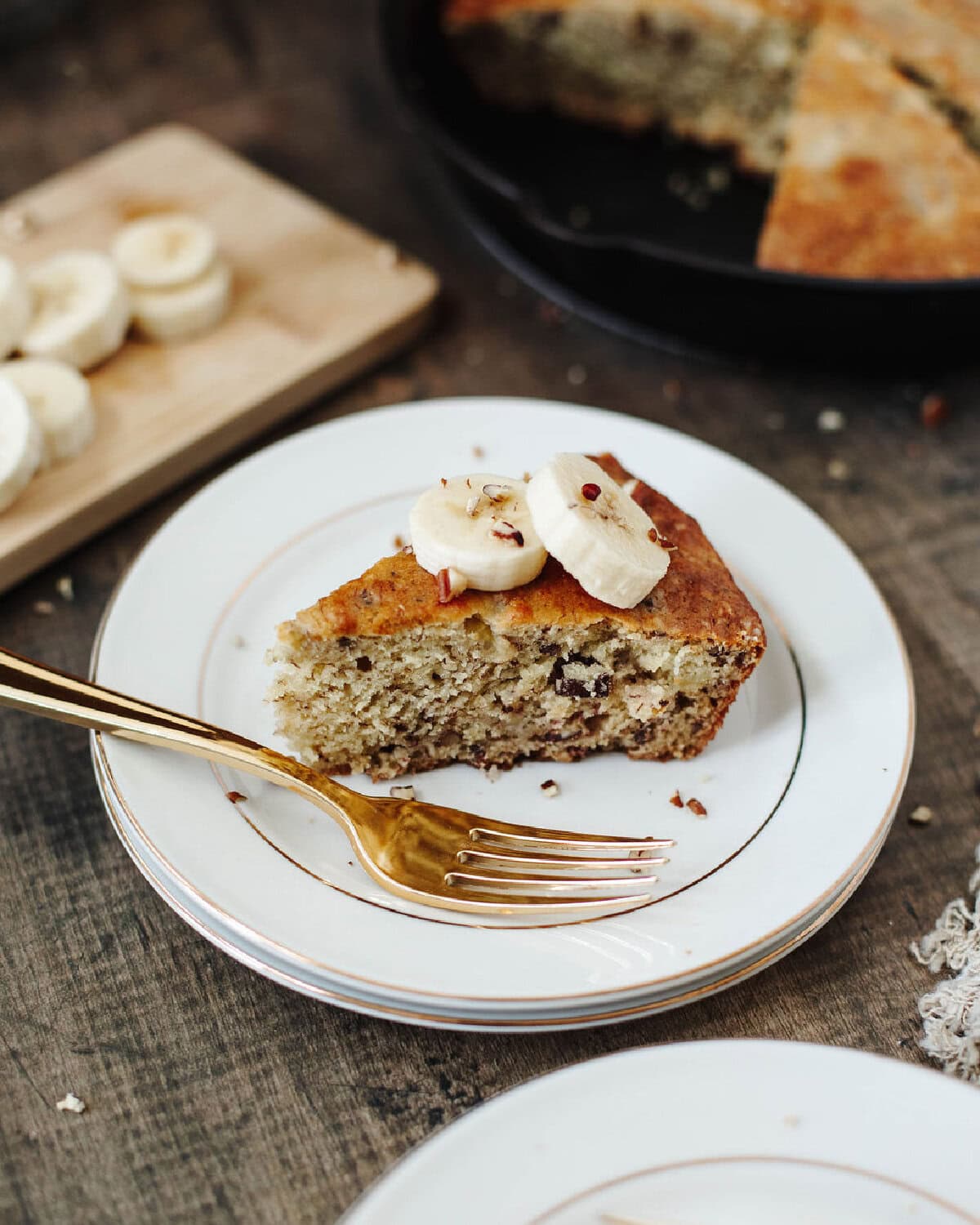 Warm slice of banana bread served on a plate.