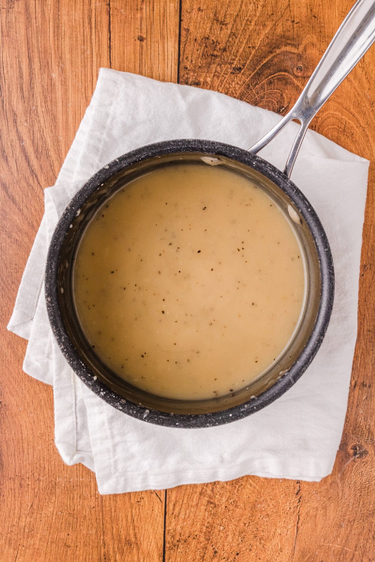 homemade chicken gravy made in a black saucepan.