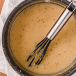 a black whisk stirring homemade gravy made without drippings.