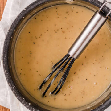 a black whisk stirring homemade gravy made without drippings.