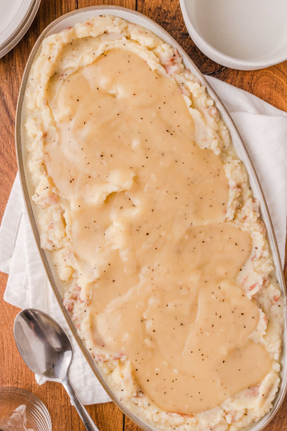 homemade chicken gravy from scratch poured on top of mashed potatoes.