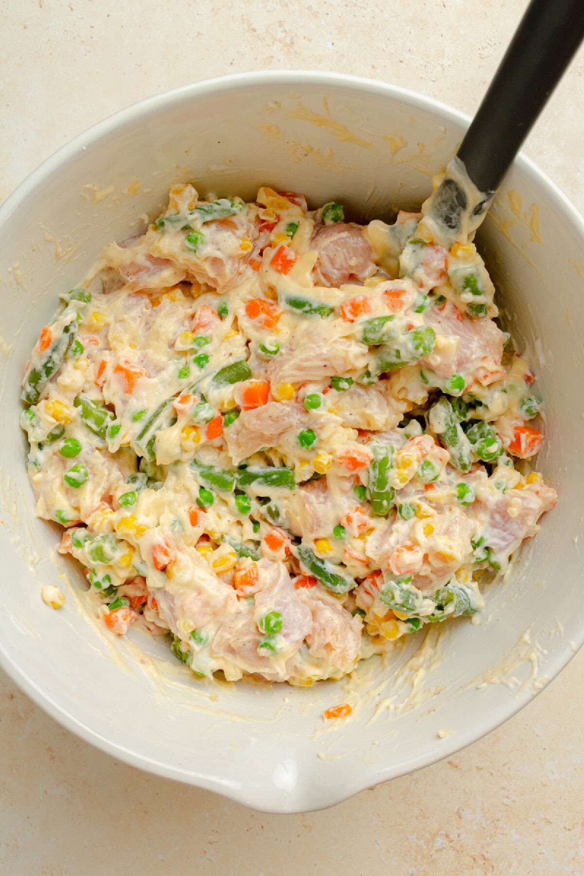 Chicken mixture combined with vegetables and seasonings for chicken stuffing casserole.