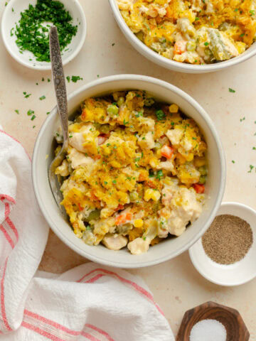 A serving of Chicken Stuffing Casserole in a bowl with a fork.