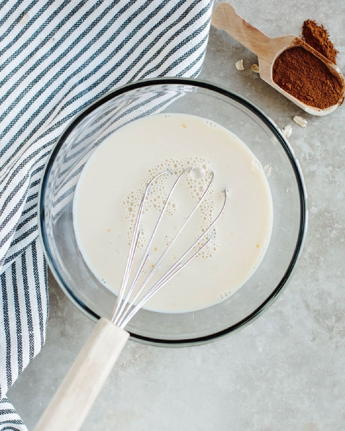 wet ingredients added to a glass mixing bowl to make scones.
