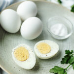 sliced hard boiled eggs on a plate ready to serve.