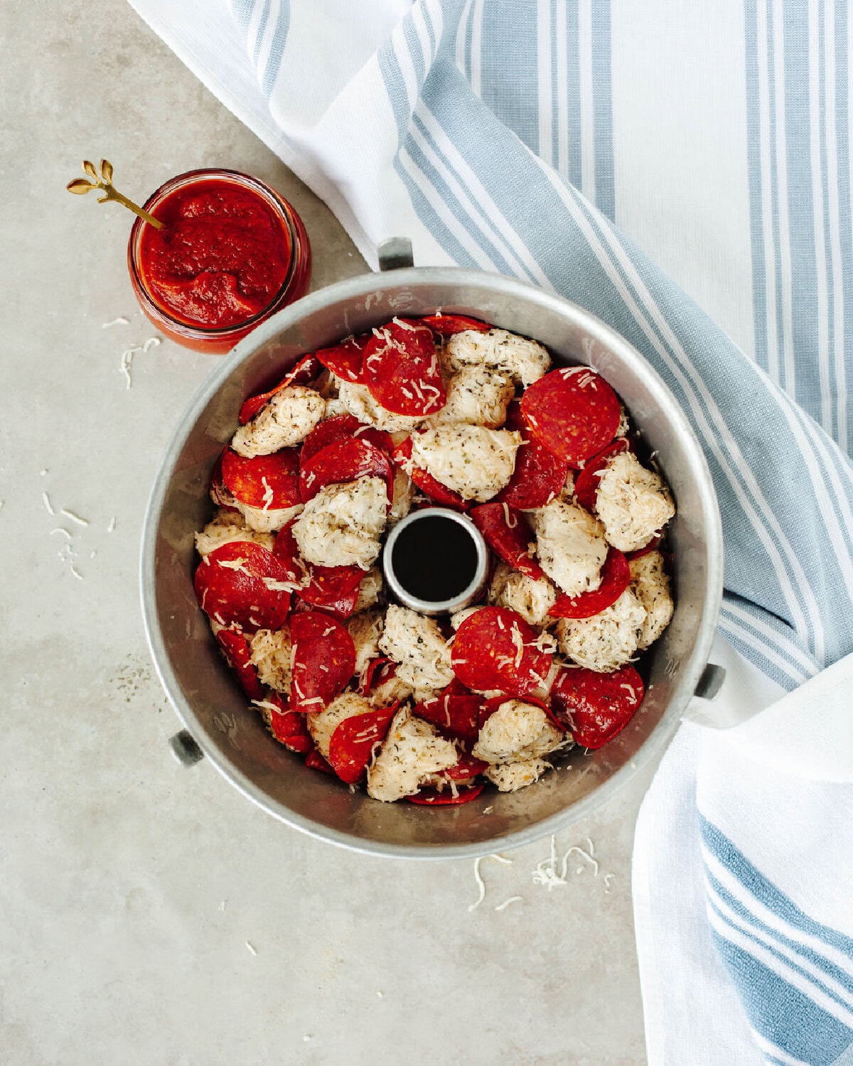 pull apart pizza bread in a bundt pan ready for the oven.
