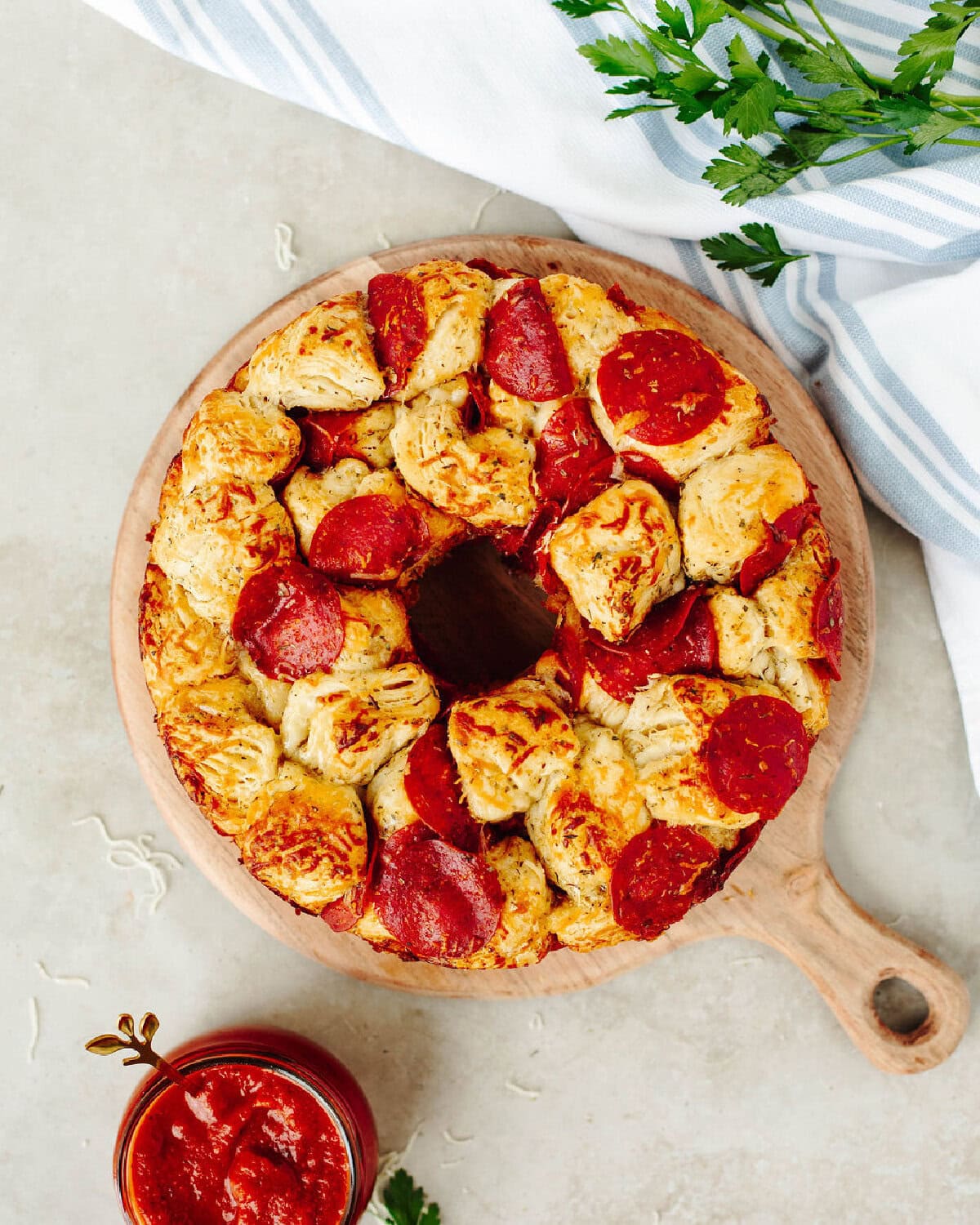 baked pull apart pizza bread on a wood serving tray ready to enjoy.