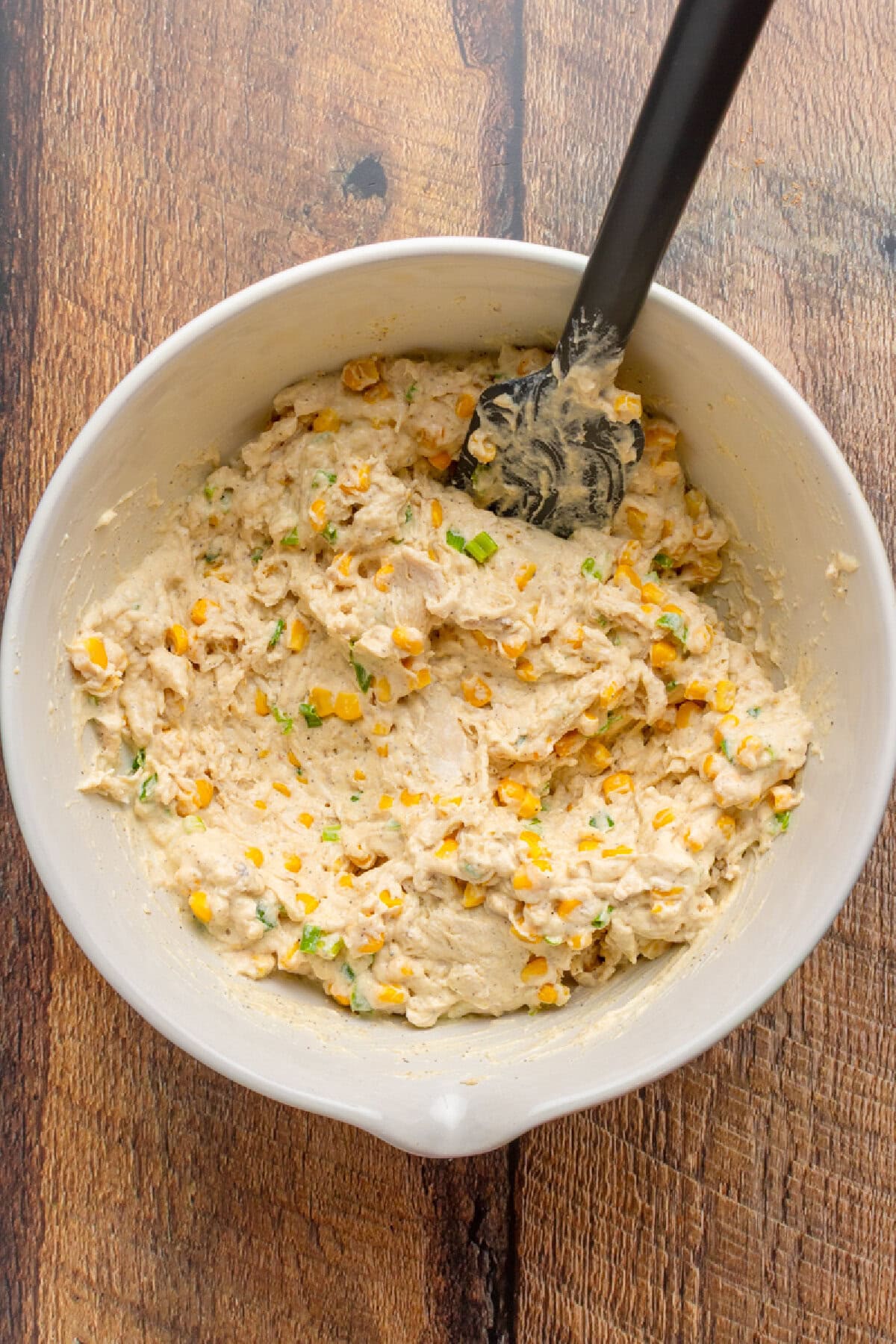 Creamy chicken mixture combined in a mixing bowl and ready to transfer to baking dish.
