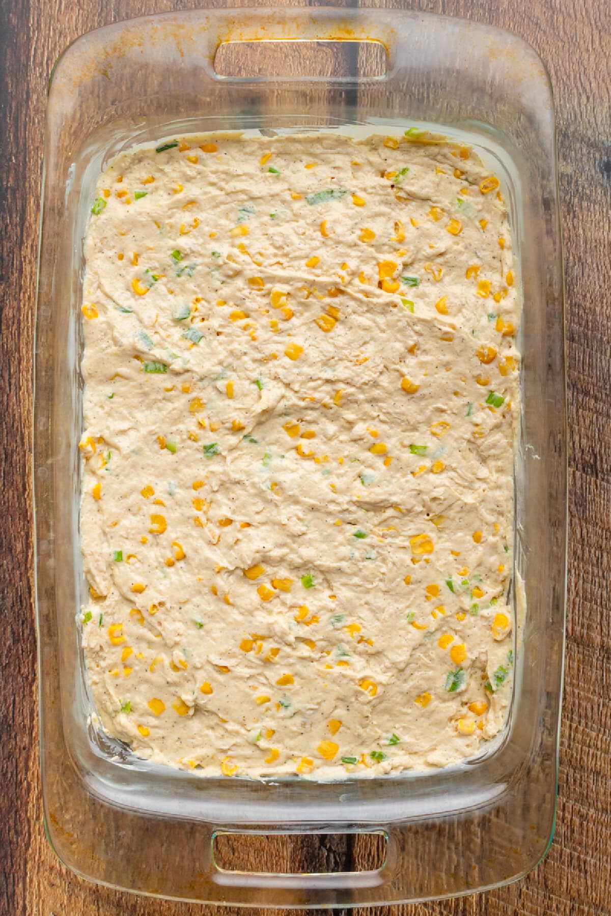 Creamy chicken mixture spread evenly into a baking dish.