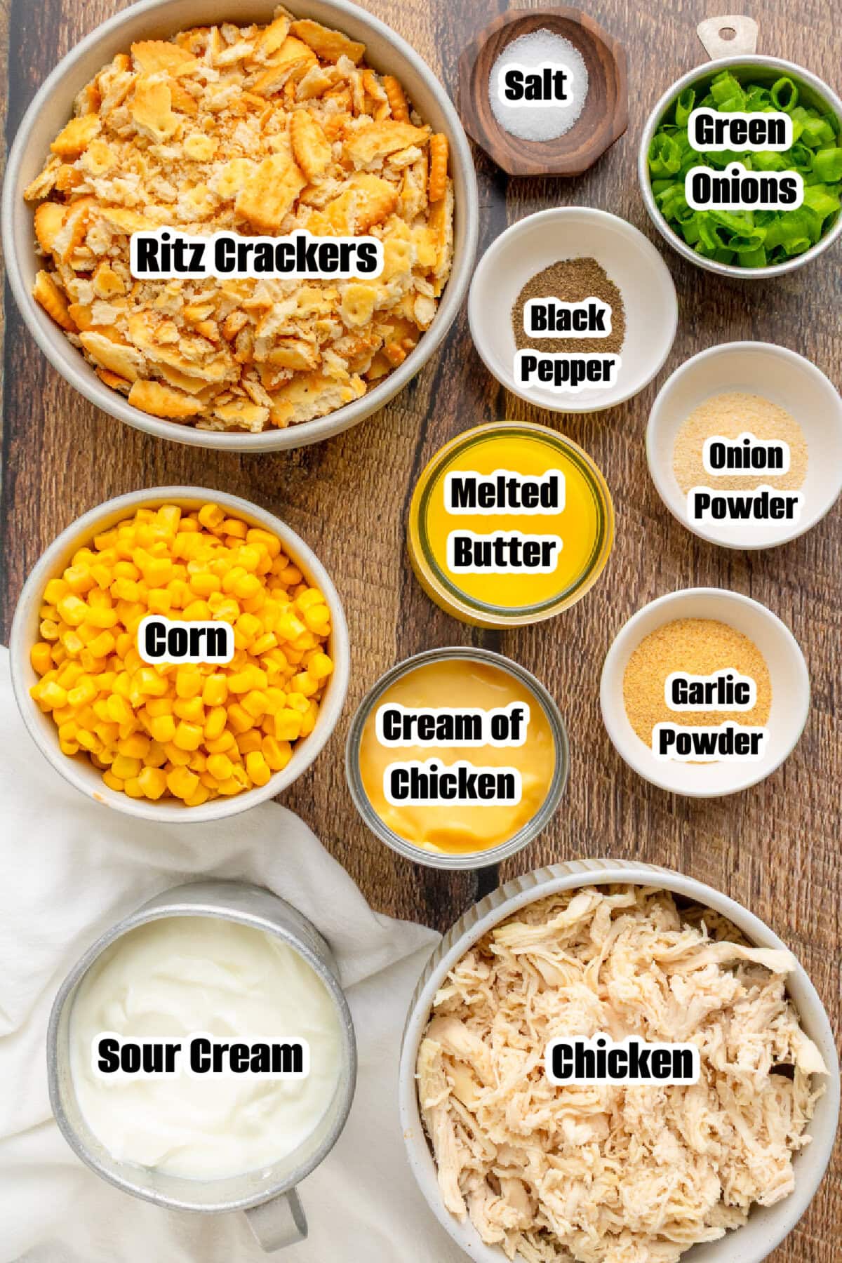 Ingredients for chicken casserole including cooked chicken, ritz crackers, and creamy sauce.