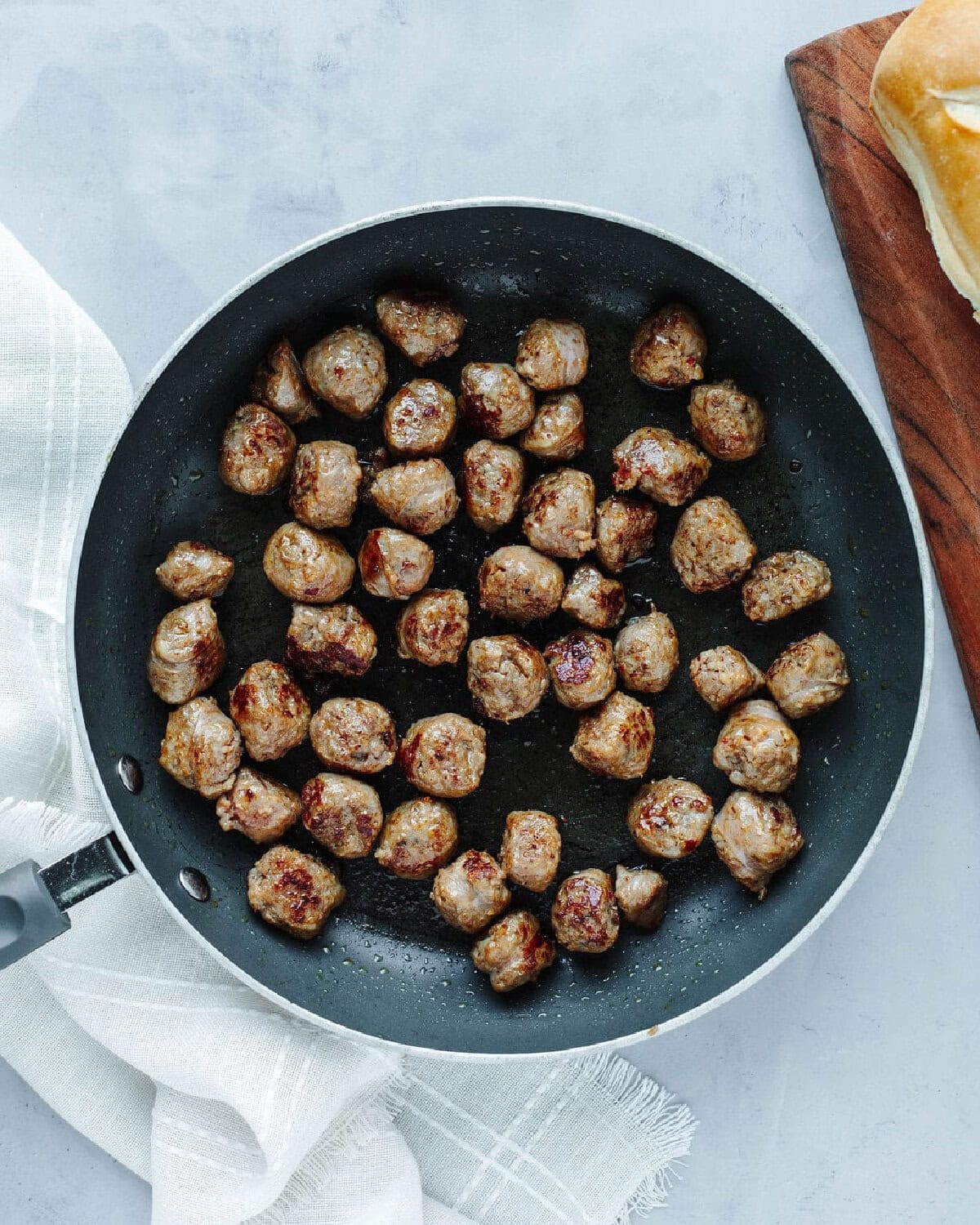 diced sausage pieces cooked in a black skillet.