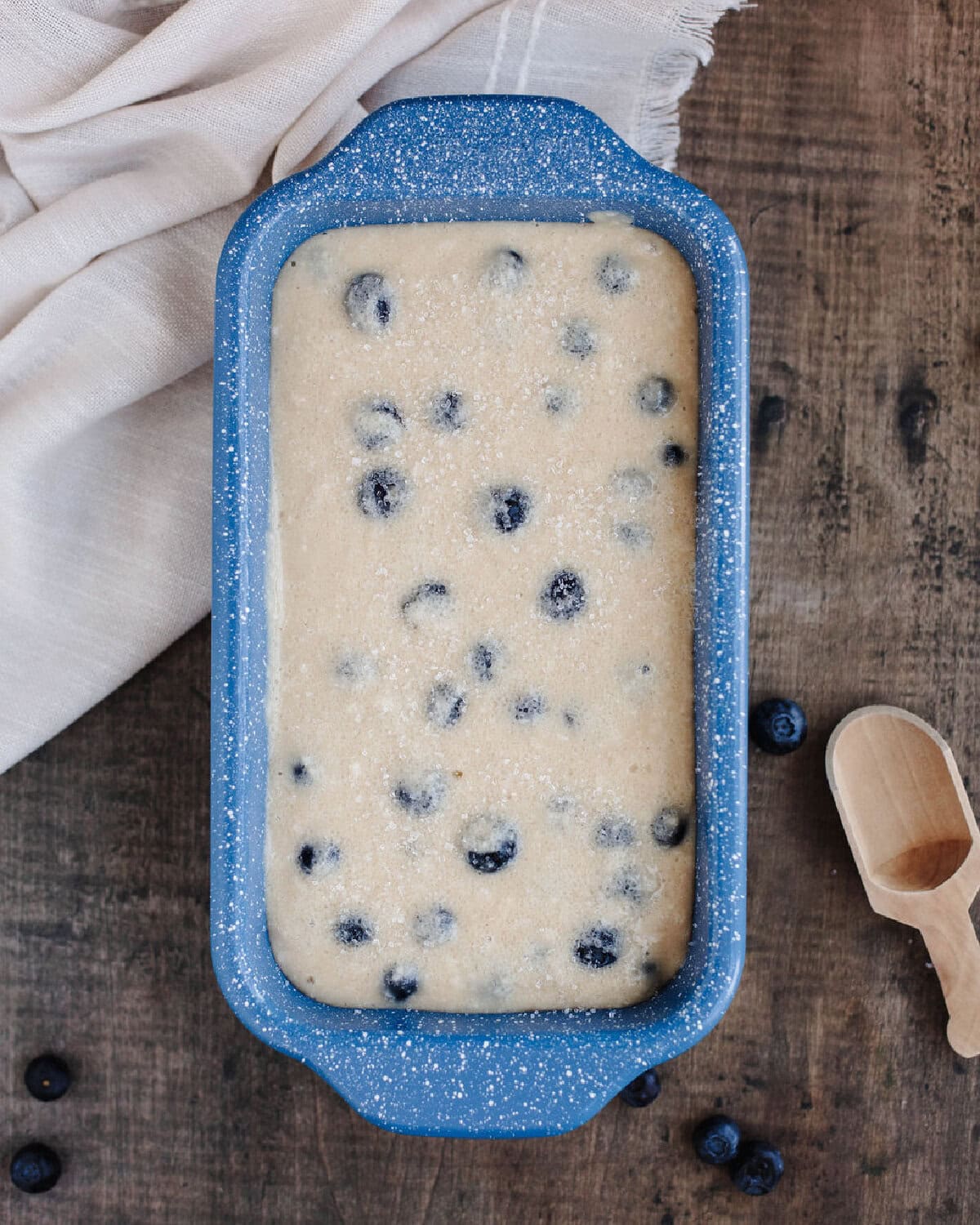 Blueberry Muffin Bread batter poured into a prepared loaf pan.