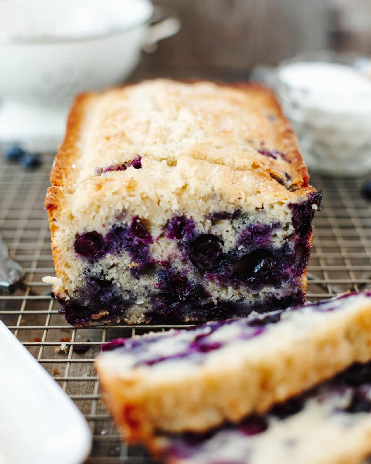 An up close look at sliced blueberry muffin bread showing the juicy blueberries.