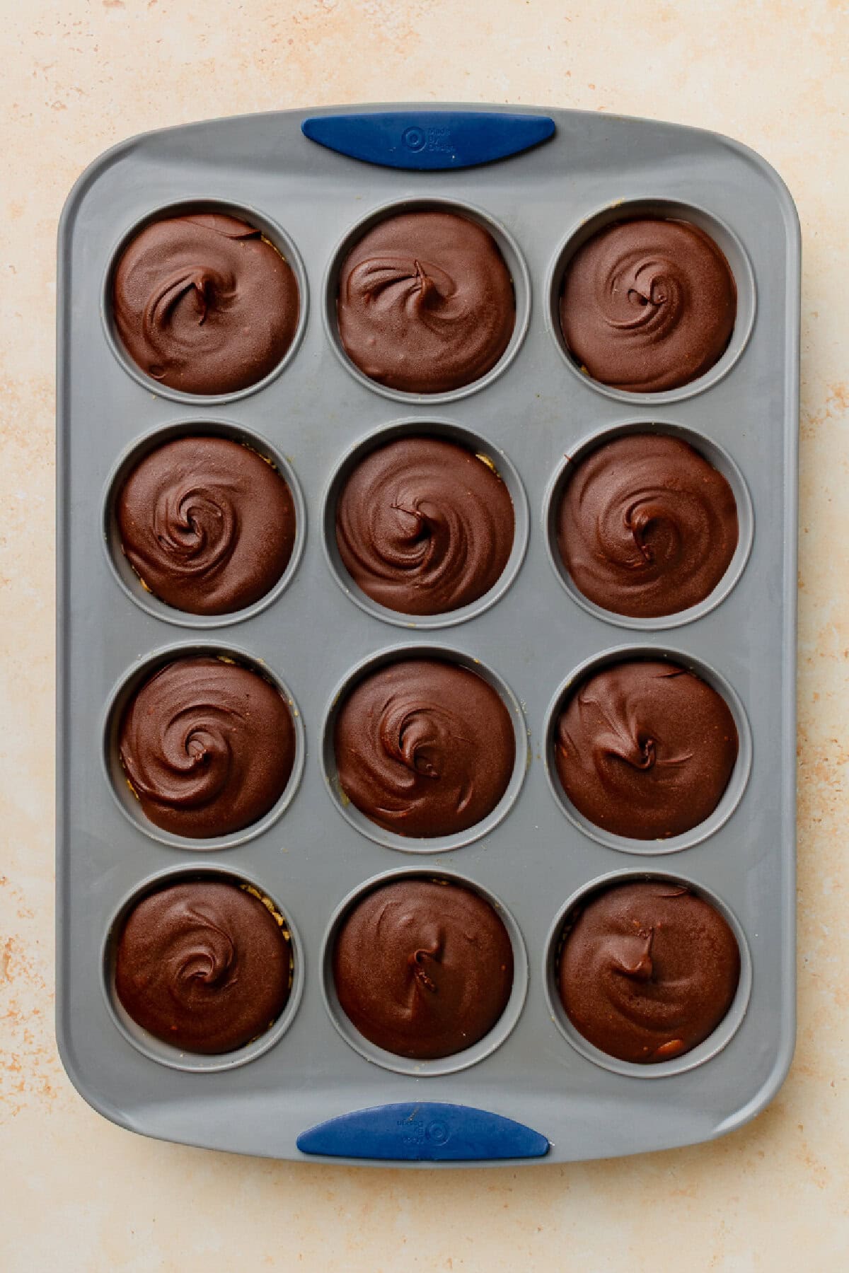 Chocolate peanut butter rice krispies cups in a muffin pan ready to serve.