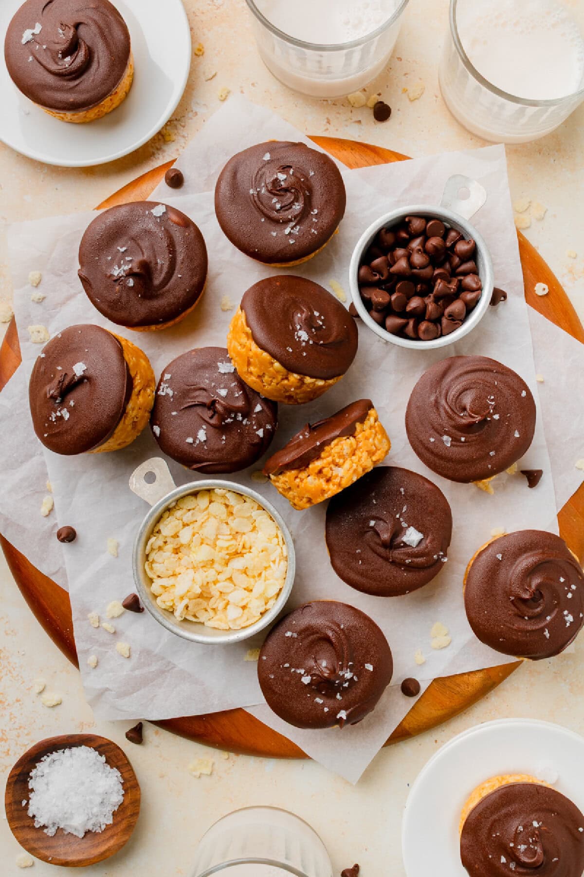 Chilled chocolate peanut butter rice krispy cups on a wood serving board.