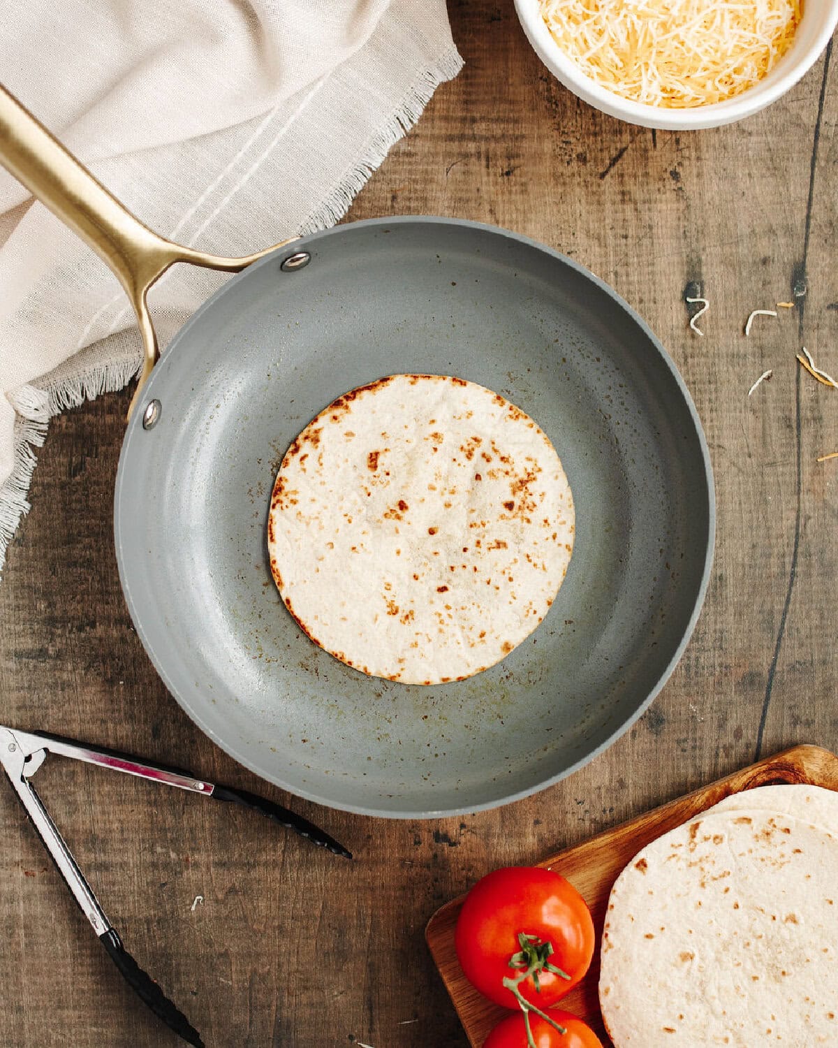A flour tortilla toasted in a skillet.