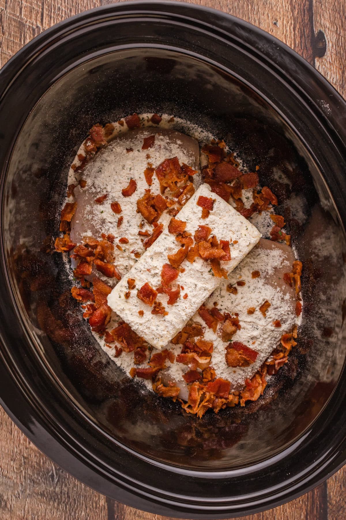 Cream cheese, chicken, bacon, and Ranch seasoning in a crock-pot.