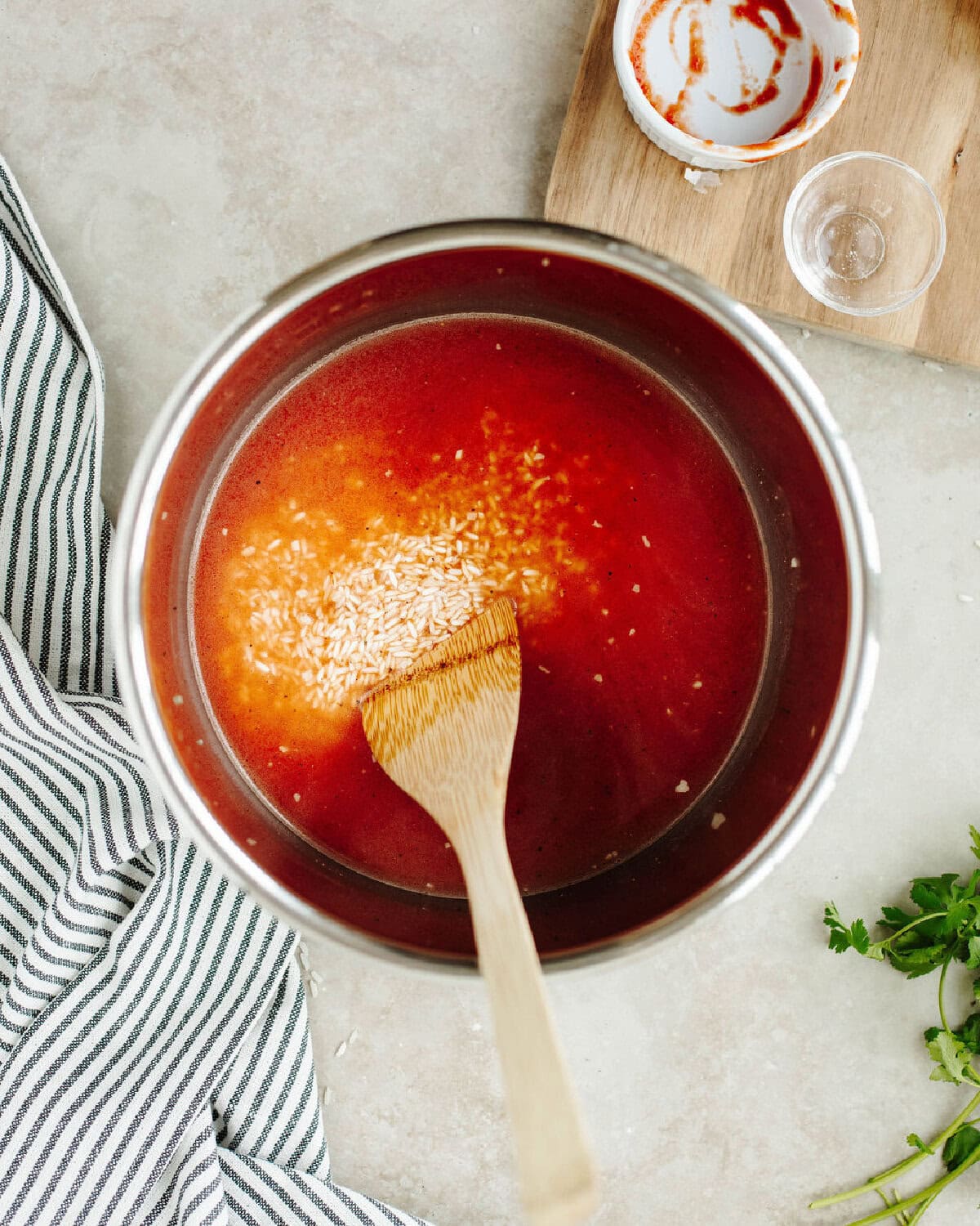 Tomato sauce and water added to rice and seasonings.