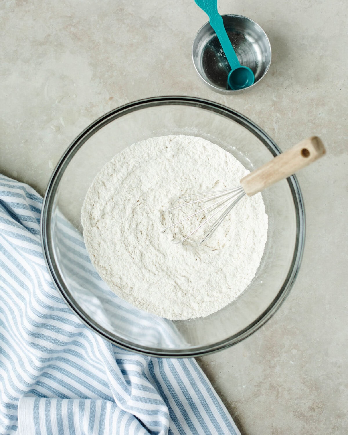 Flour, baking soda, and salt whisked together in a glass bowl.